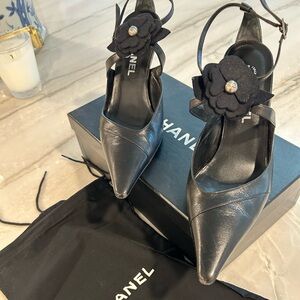 CHANEL Black Leather Pointed Toe Slingback Heels with Camellia Accent